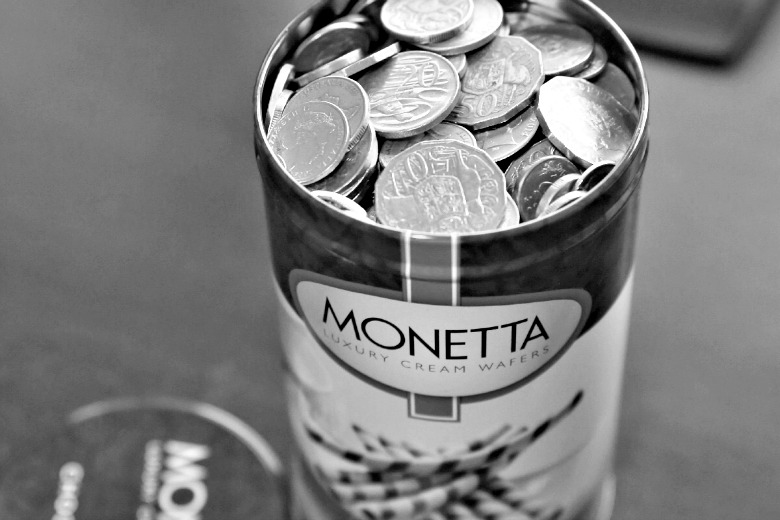 Coins saved in a biscuit tin