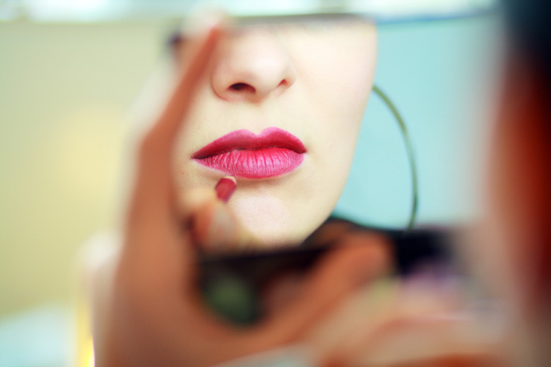 Woman Applying Lipstick